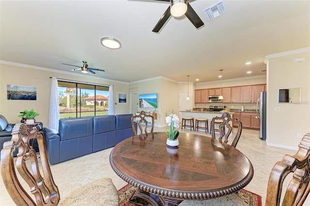 dining room with crown molding and ceiling fan