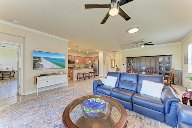 living room featuring crown molding, light tile patterned floors, and ceiling fan