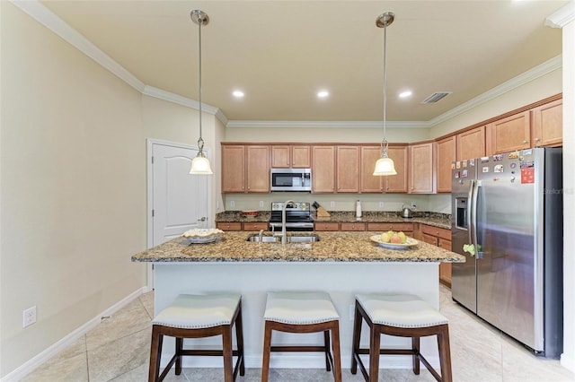 kitchen featuring appliances with stainless steel finishes, a center island with sink, light tile patterned floors, and pendant lighting