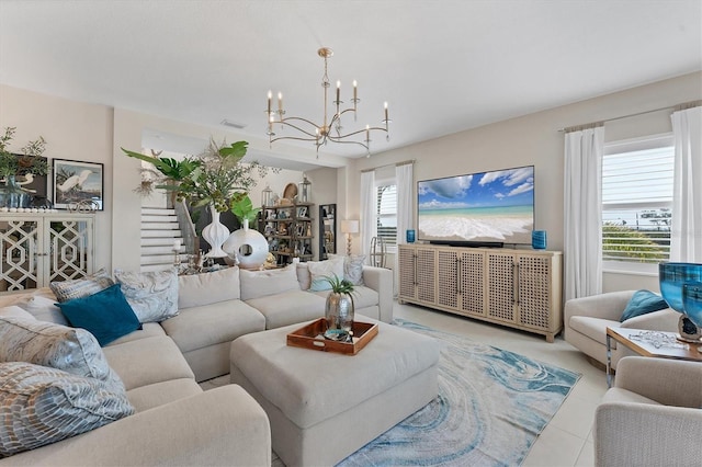 living room featuring a notable chandelier, a healthy amount of sunlight, and light tile patterned flooring