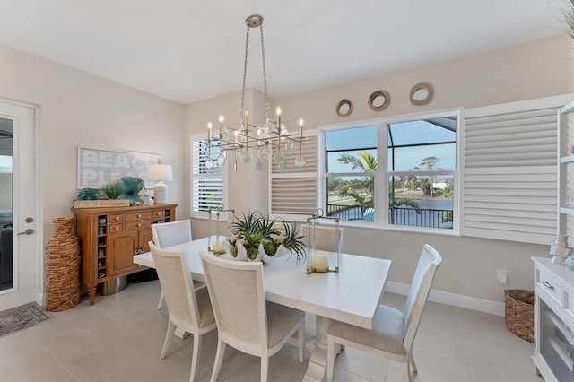 tiled dining area with a notable chandelier