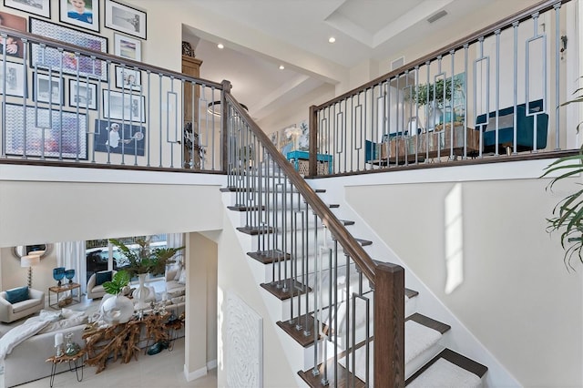 stairs featuring a towering ceiling