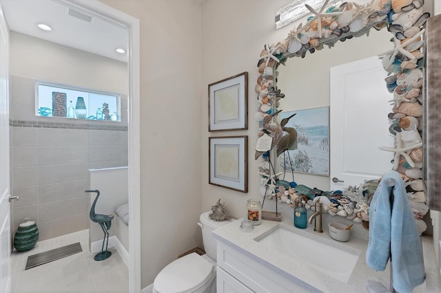 bathroom with tile patterned flooring, vanity, and toilet