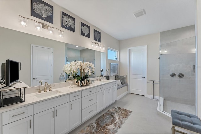 bathroom featuring tile patterned flooring, vanity, and a shower with shower door