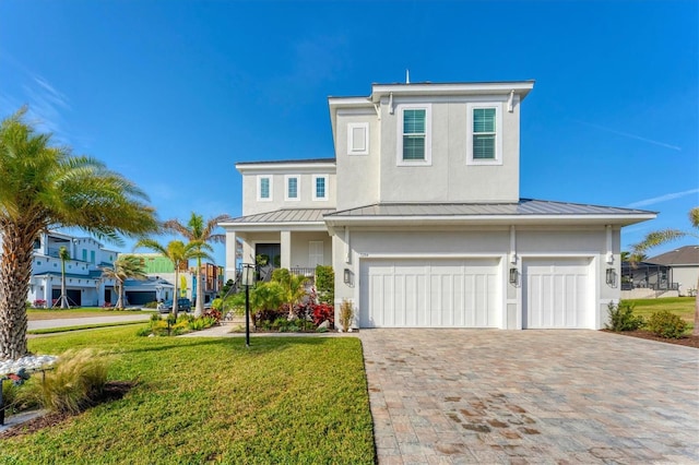 view of front facade with a garage and a front lawn