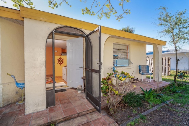 view of exterior entry featuring a patio