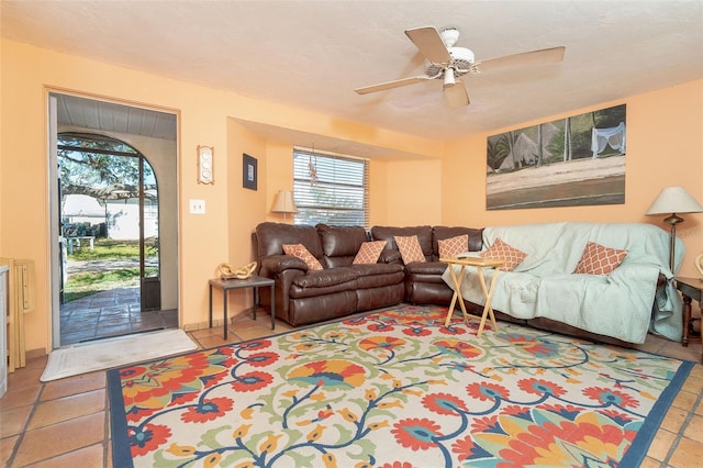 living room featuring tile patterned flooring and ceiling fan