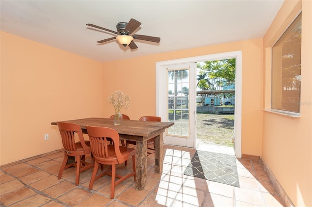 dining space with light tile patterned floors and ceiling fan