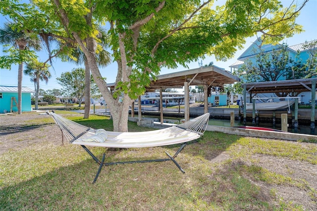 view of dock with a lawn