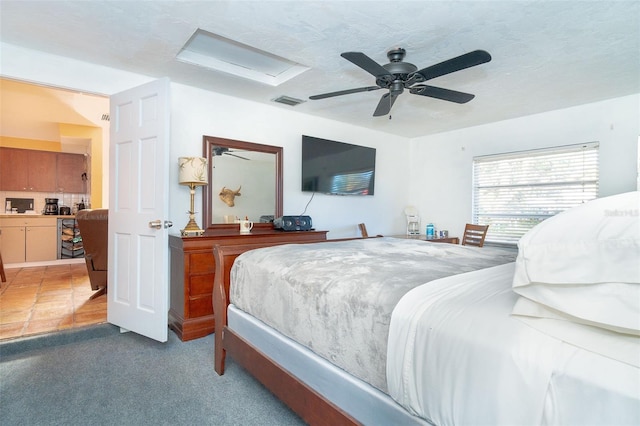 carpeted bedroom with a textured ceiling and ceiling fan