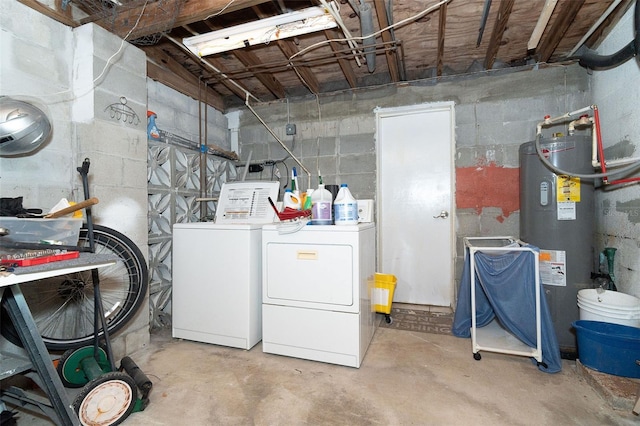 washroom with washer and dryer and water heater