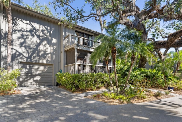 view of property exterior featuring a garage and a balcony