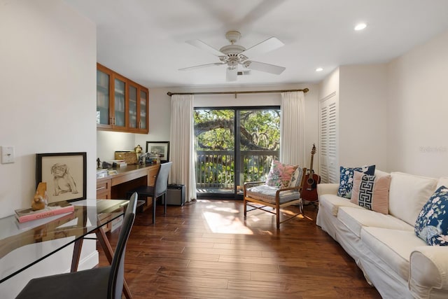 living room with ceiling fan and dark hardwood / wood-style floors