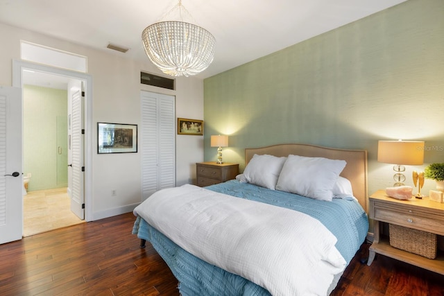 bedroom with dark wood-type flooring and a notable chandelier