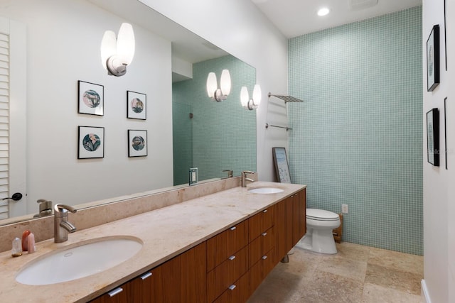 bathroom featuring a shower, vanity, and toilet