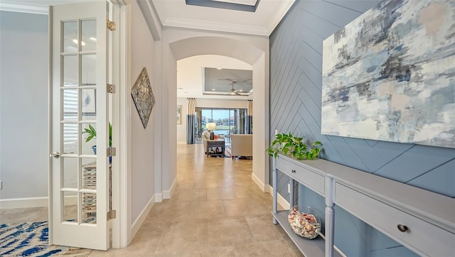 corridor with ornamental molding and light tile patterned floors