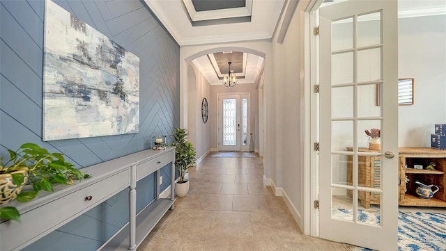 interior space featuring wooden walls, crown molding, and a notable chandelier