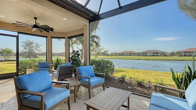 view of patio with outdoor lounge area, a water view, and ceiling fan