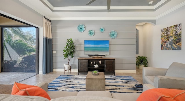 living room with ceiling fan and ornamental molding