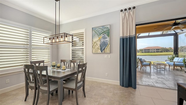 dining area with ceiling fan, a water view, light tile patterned floors, and crown molding