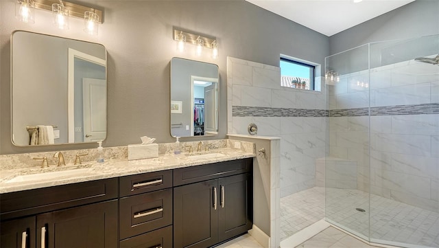 bathroom featuring tiled shower and vanity