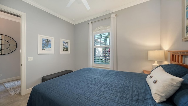 carpeted bedroom featuring ceiling fan and crown molding