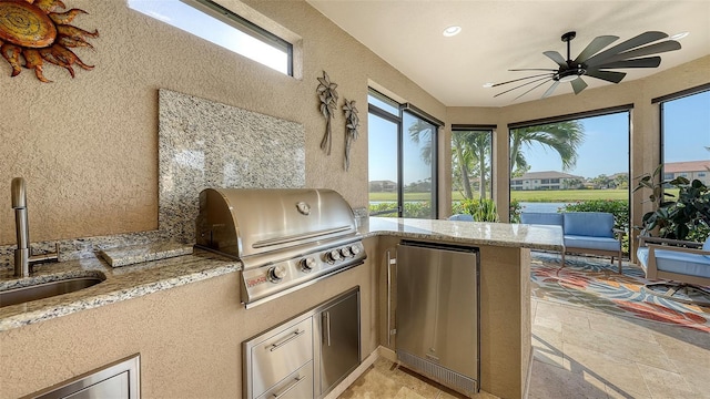 view of patio / terrace with area for grilling, ceiling fan, exterior kitchen, and sink