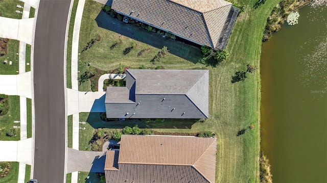 birds eye view of property with a water view