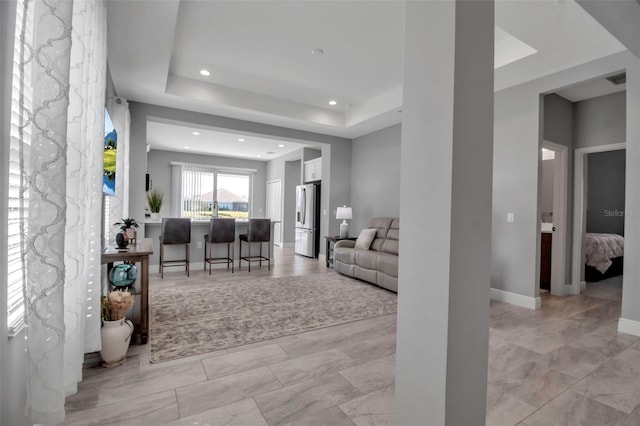 living room with a tray ceiling