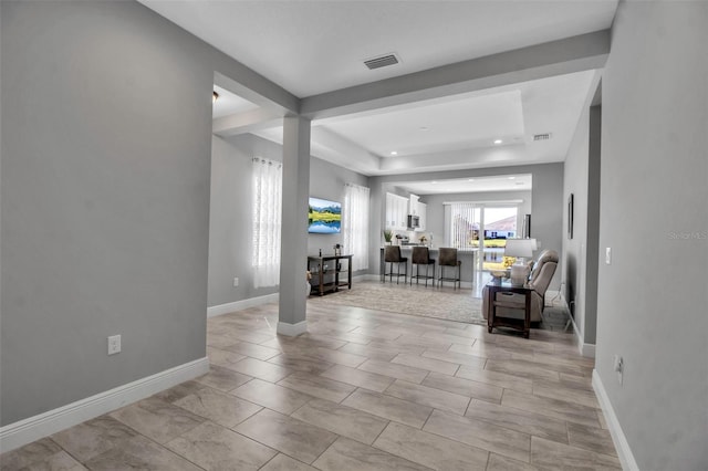 living room featuring a tray ceiling