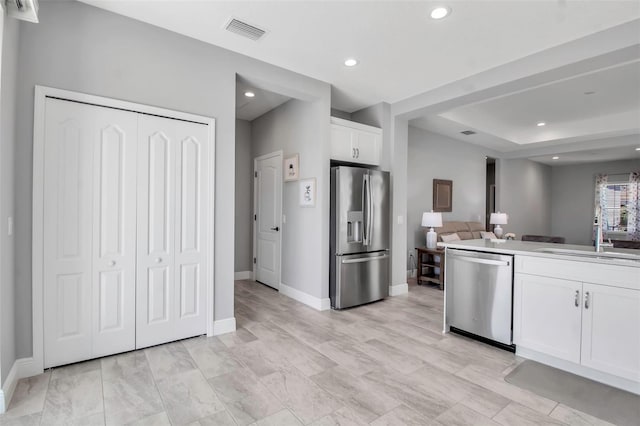 kitchen with sink, white cabinets, and stainless steel appliances