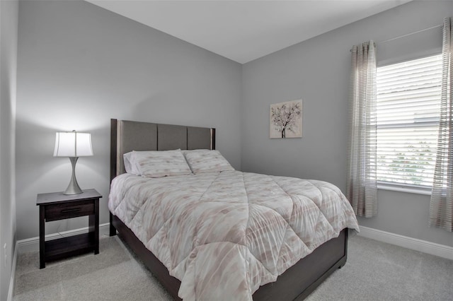 bedroom featuring light colored carpet