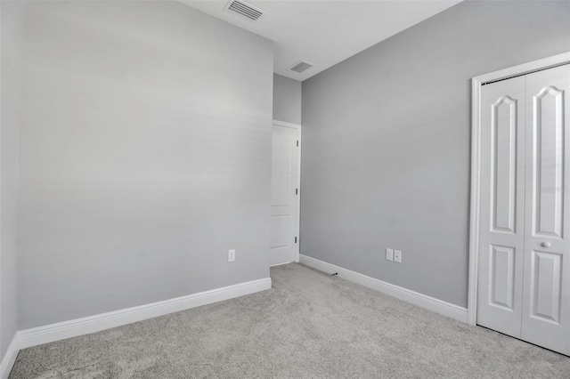 unfurnished room with light colored carpet