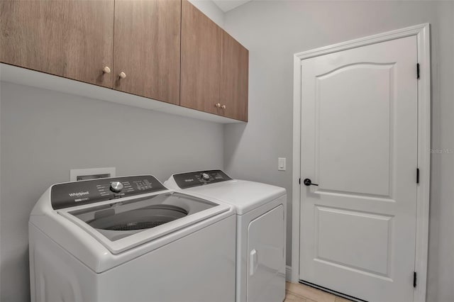 laundry area featuring cabinets and washing machine and clothes dryer