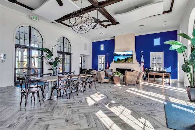 dining area with ceiling fan, french doors, light parquet flooring, and beamed ceiling