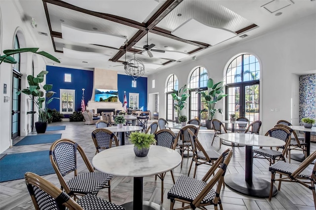 dining area featuring ceiling fan, beam ceiling, french doors, and coffered ceiling