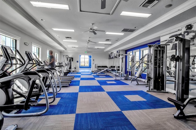 gym with ceiling fan and ornamental molding