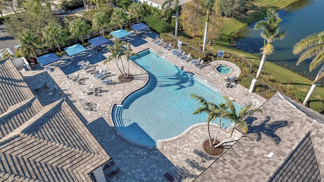 view of swimming pool featuring a water view and a patio