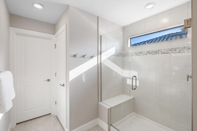 bathroom featuring tile patterned floors and an enclosed shower