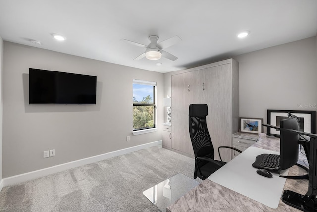 carpeted office featuring ceiling fan