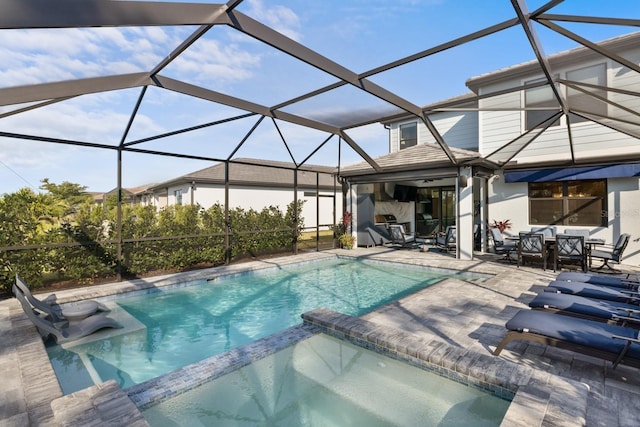 view of swimming pool featuring glass enclosure and a patio area