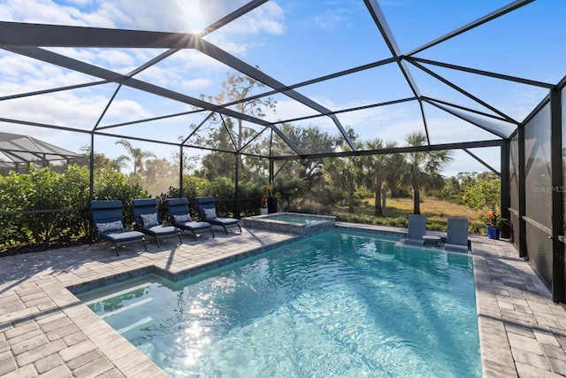 view of swimming pool featuring a lanai, a patio area, and an in ground hot tub