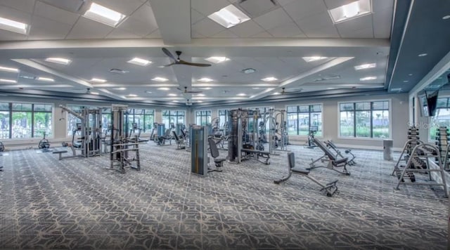 workout area with ceiling fan and carpet