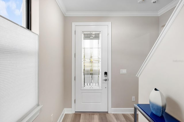 entryway featuring ornamental molding and light hardwood / wood-style floors