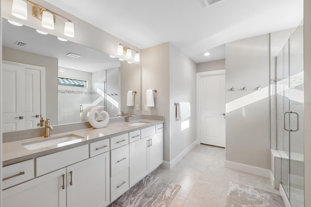 bathroom featuring vanity, tile patterned flooring, and a shower with door