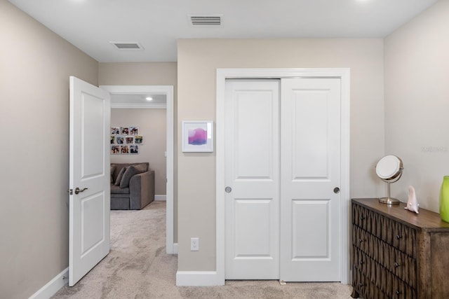 hall with light colored carpet