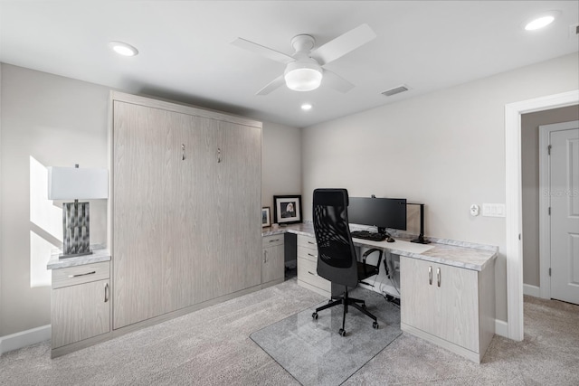 home office with ceiling fan and light carpet