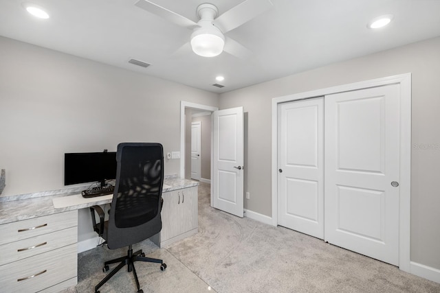 home office featuring ceiling fan and light carpet