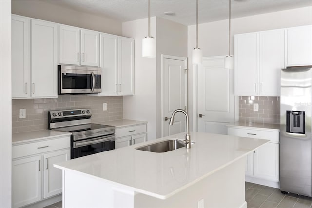 kitchen with white cabinets, sink, an island with sink, and appliances with stainless steel finishes