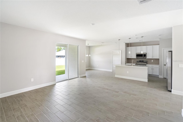 unfurnished living room with sink